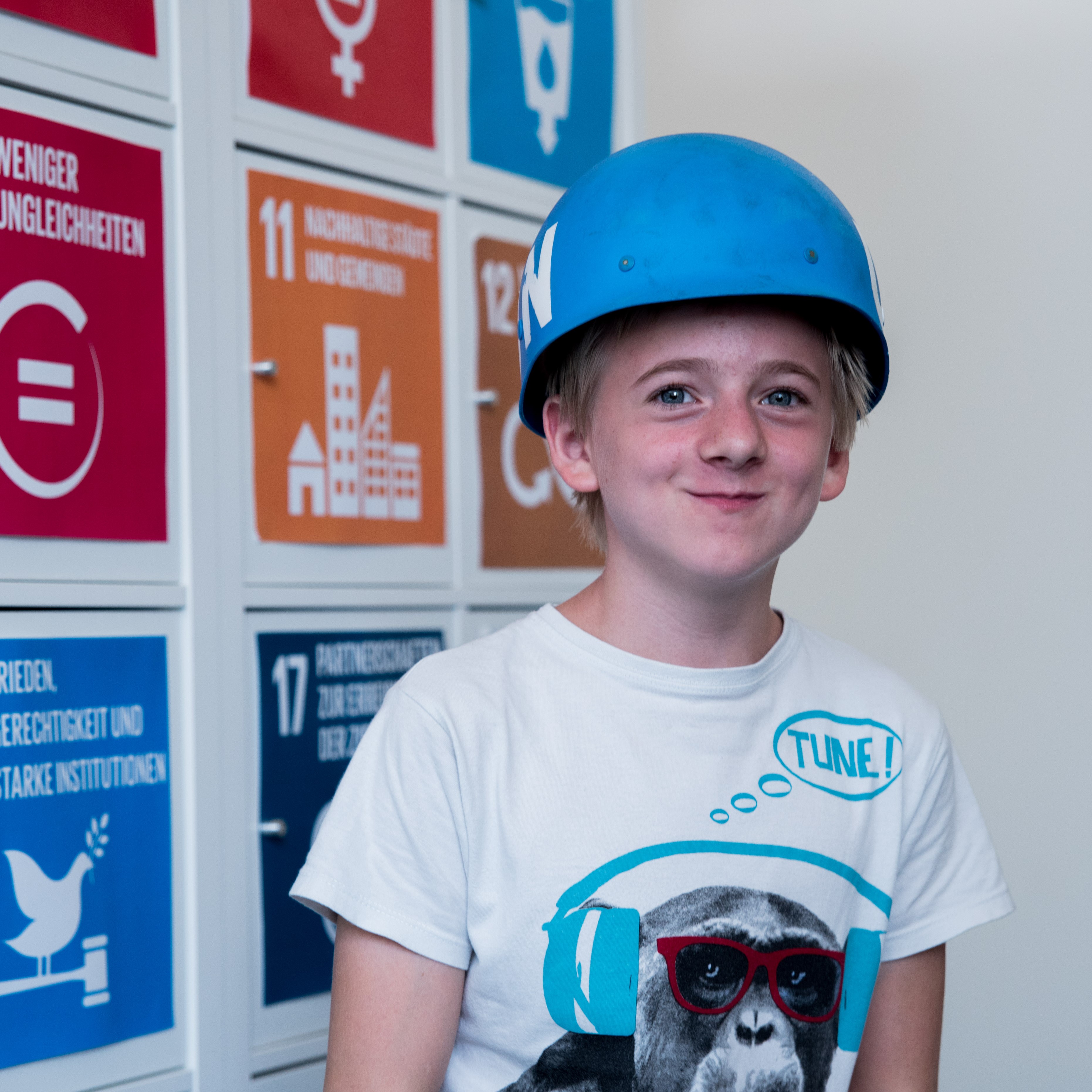 Boy posing with a "blue helmet"