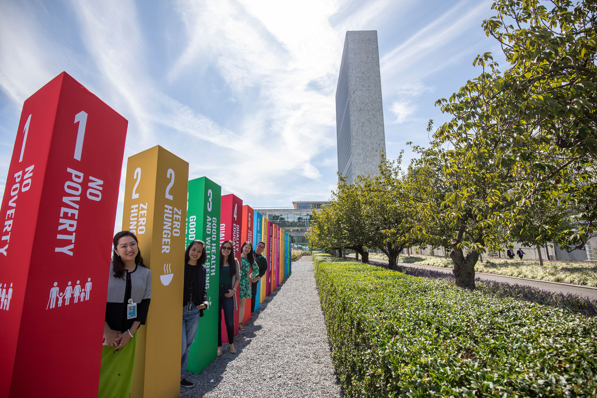 <p><sub>UN Staff members stand outside the SDG Action Zone on the lawn of UN Headquarters.</sub></p>
