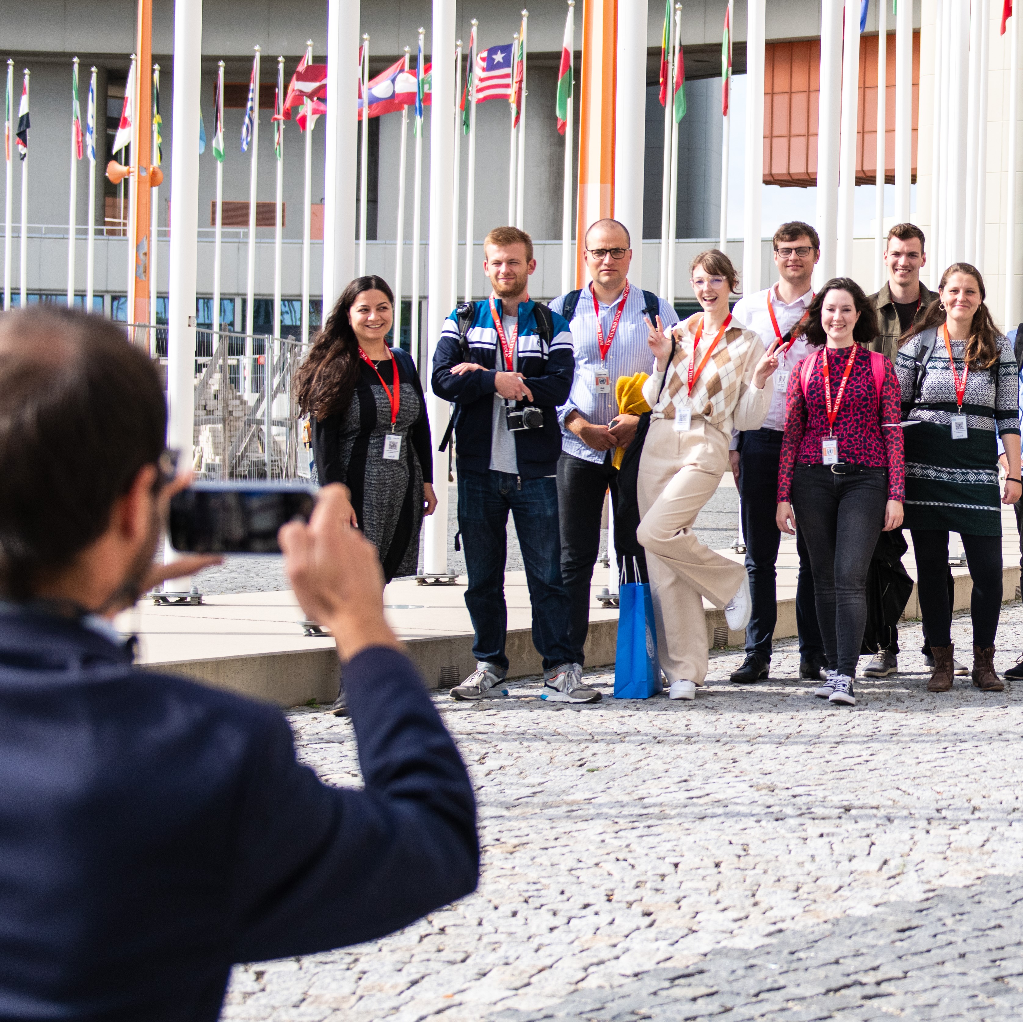Group of visitors posing for a photo during a guided tour of the UN in Vienna