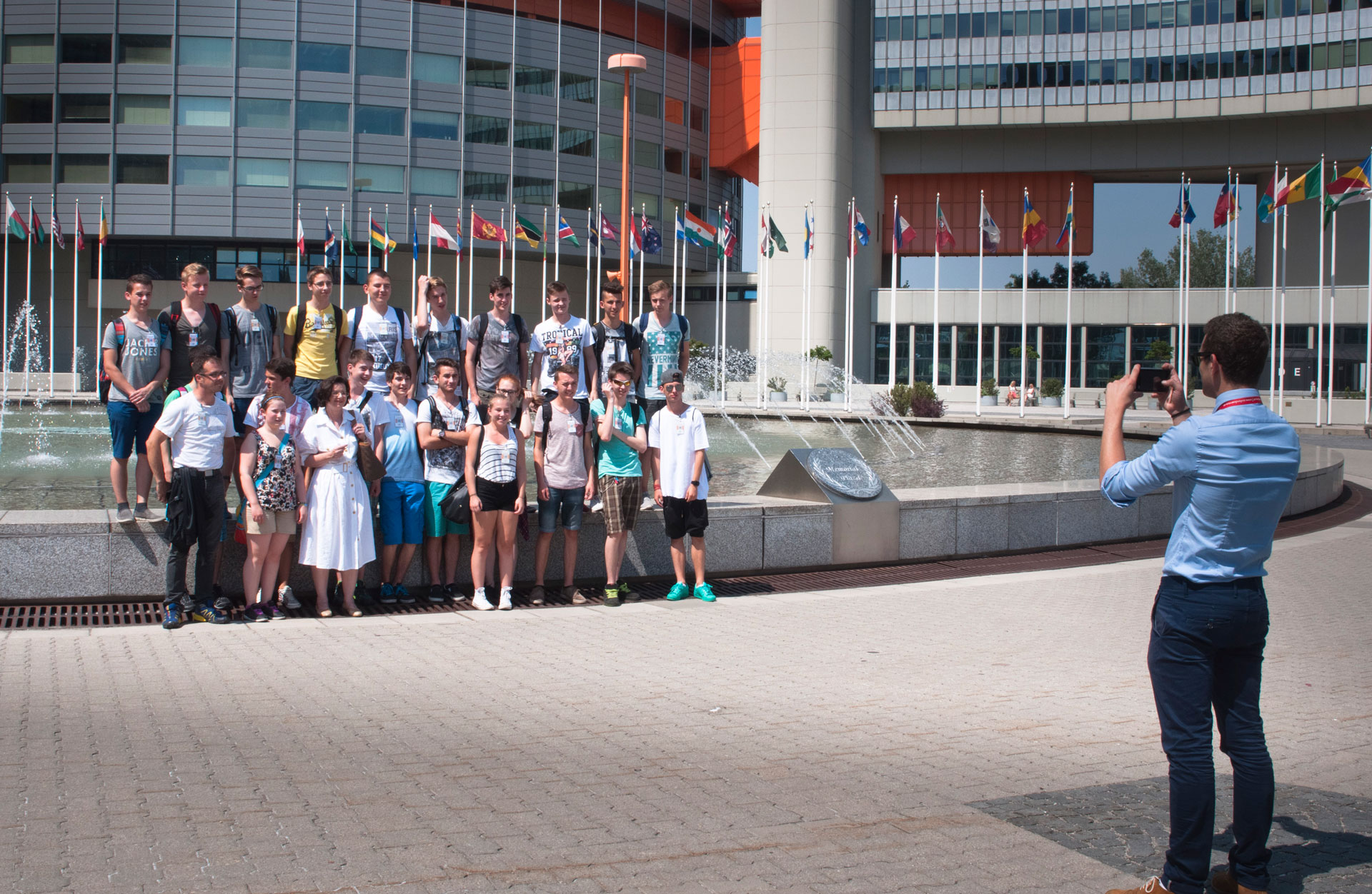 School class posing for group photo on UN Vienna Memorial Plaza